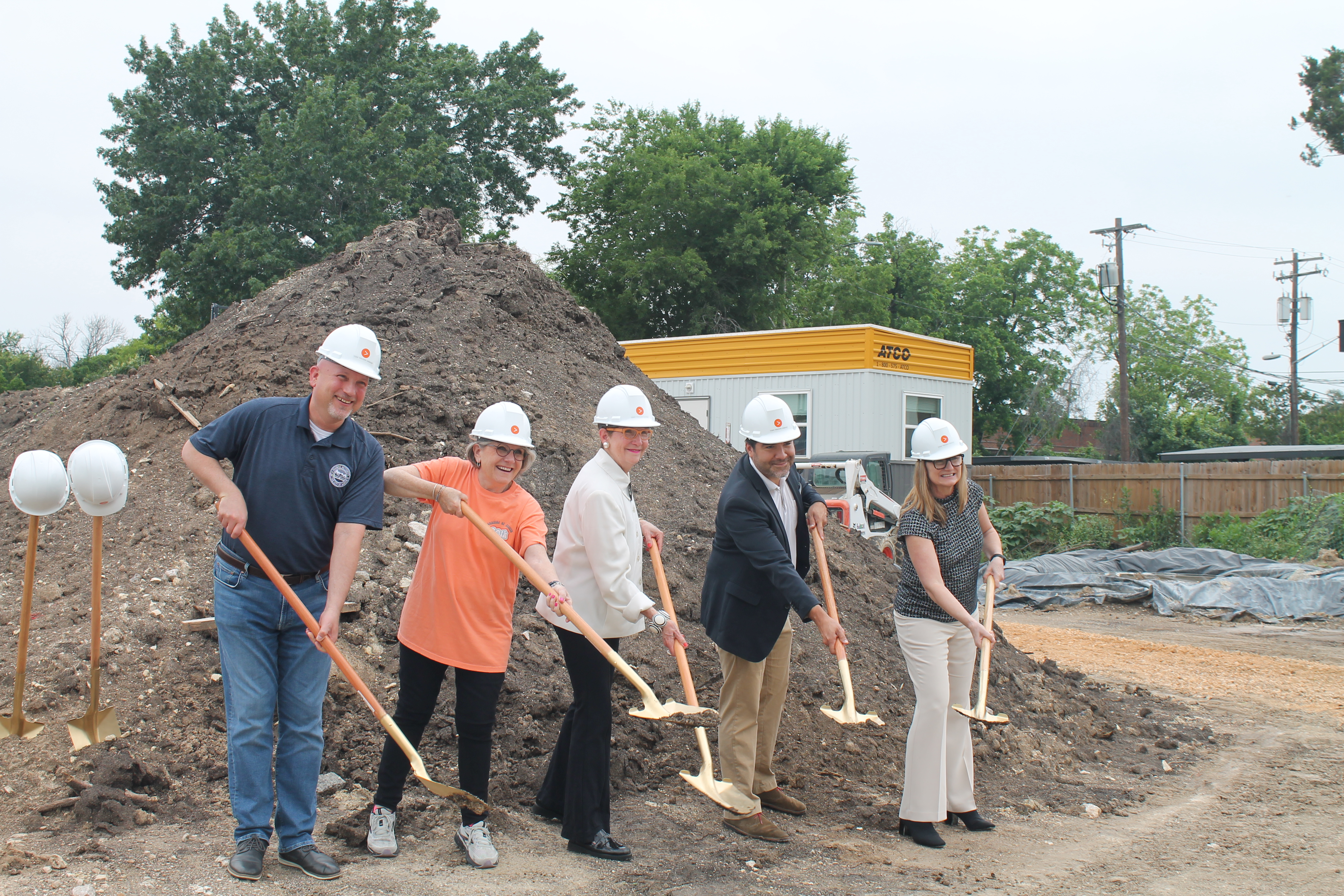Image shows five people holding dirt-filled shovels at the groundbreaking ceremony for the new community called Cairn Point Cameron groundbreaking ceremony.
