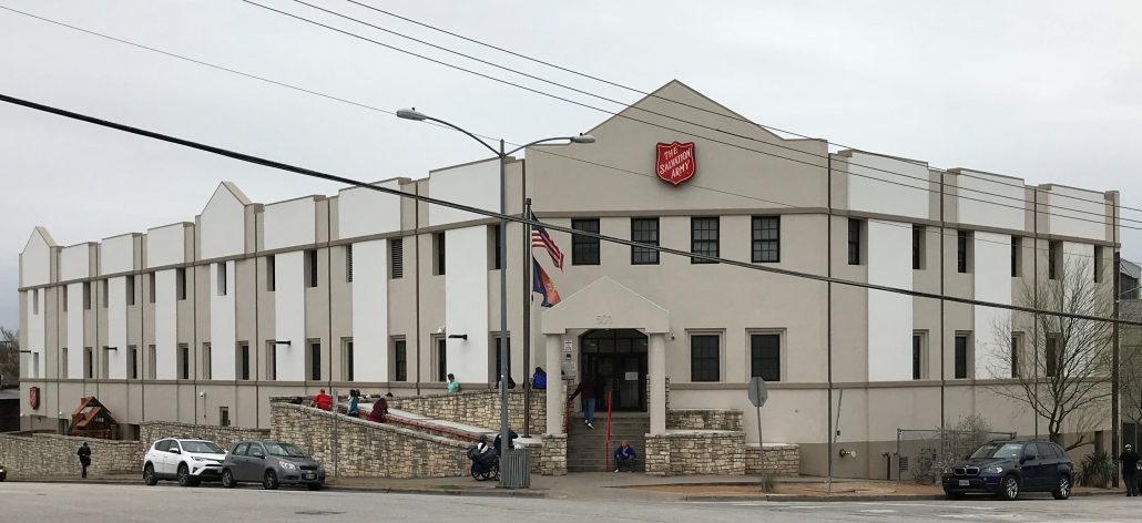 Image of white Salvation Army brick building in downtown Austin