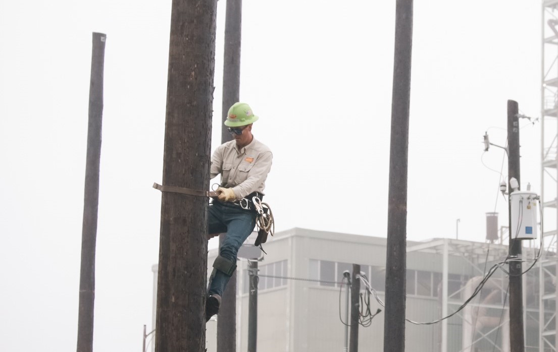 Person climbing a utility pole during Austin Energy training