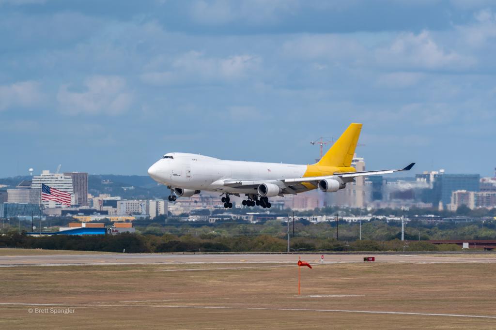 Photo of a large aircraft landing at AUS during Formula One.