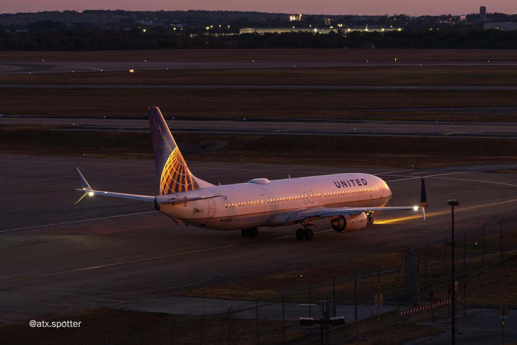 A clear photo of a United Airlines plane waiting to take off from AUS at dusk.