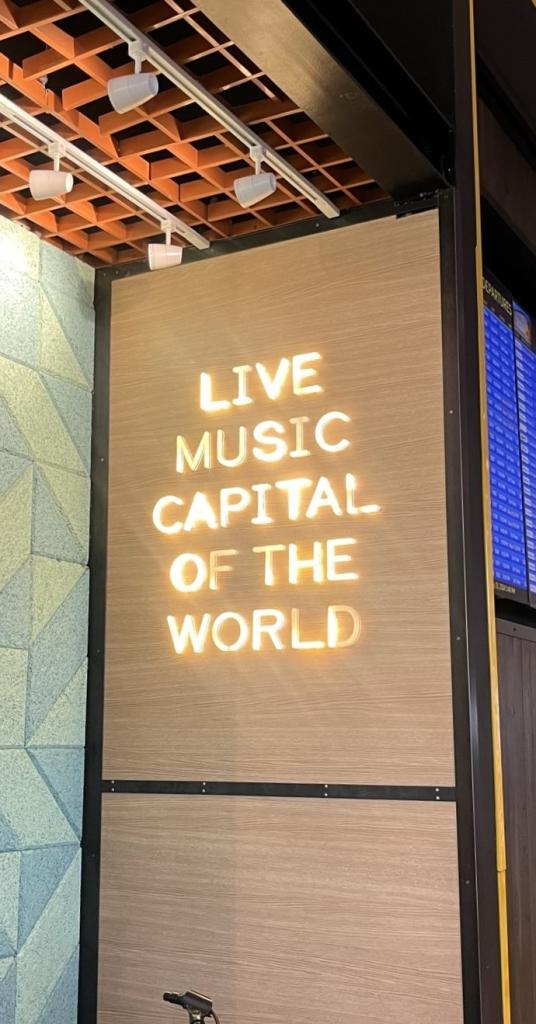 Photo of a neon sign at AUS that reads" Live Music Capital of the World"