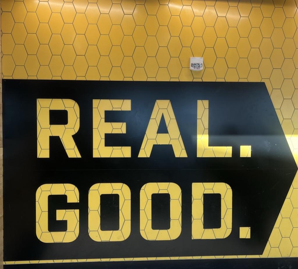 Photo of a large sign outside of Flyrite that reads: "Real. Good."