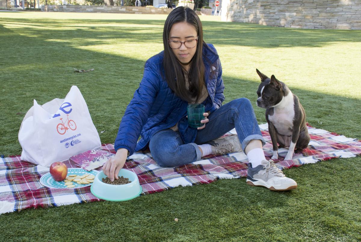 Woman has a picnic with her Boston Terrier, using her reusable bag