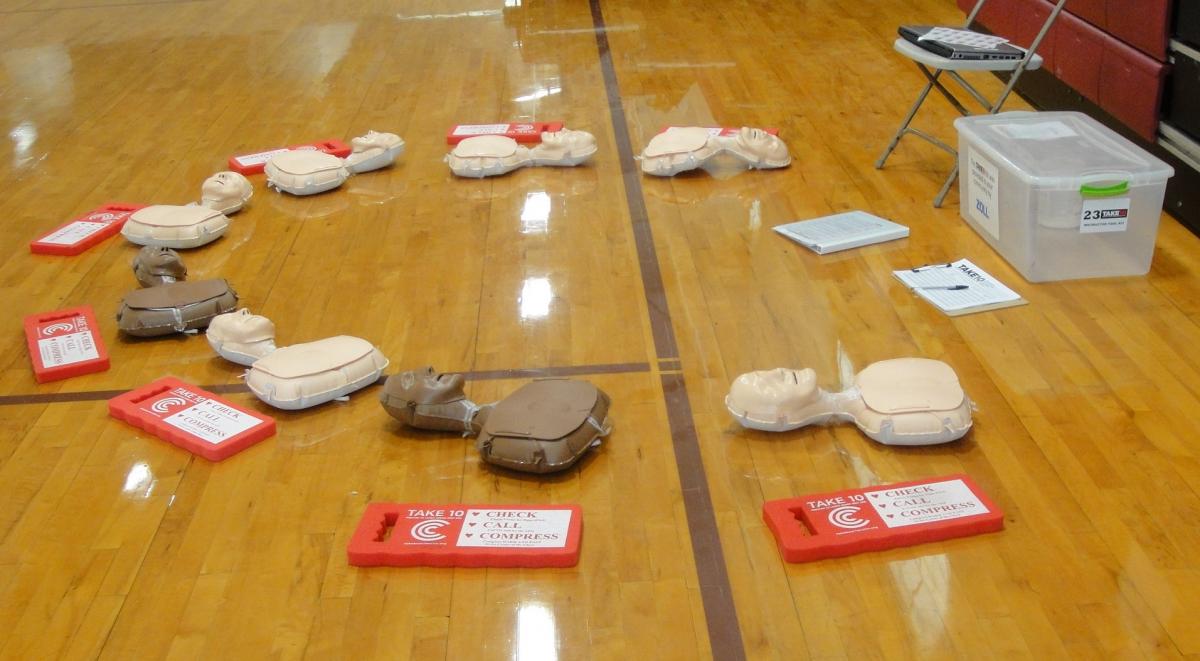 Set up for a TAKE10 Class with manikins and knee pads in a semi-circle. Trainer Guide is available for Trainer to give class.