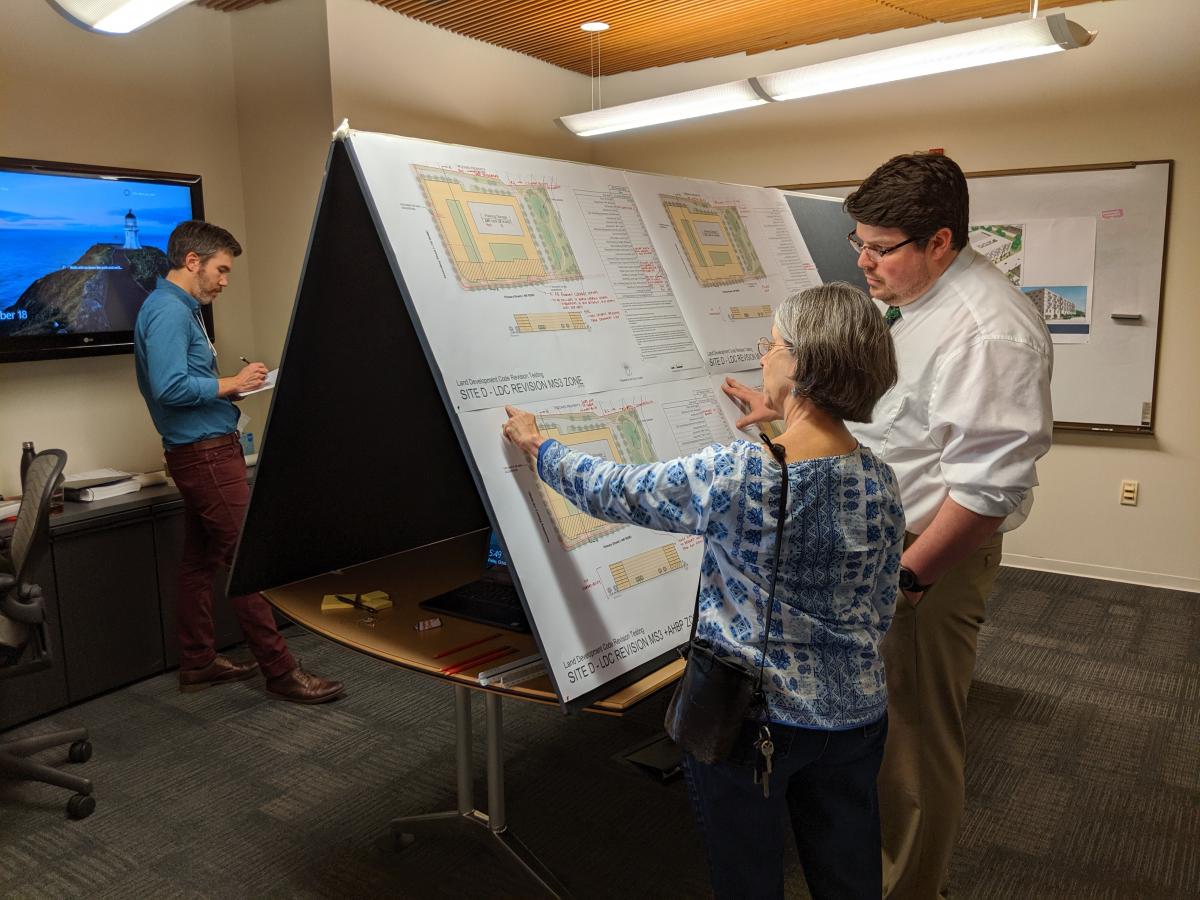 image: Participant reviews sample site with staff during Public Testing.