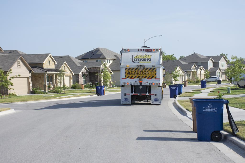 "Recycling truck collects contents from curbside carts"