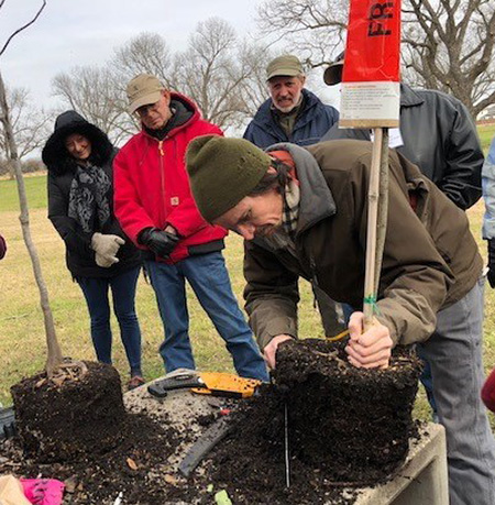 Several landscape profesionals learning to use new equipment and tools.