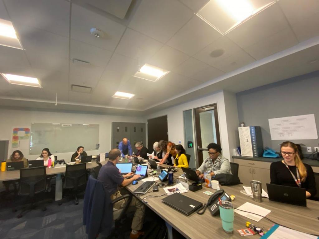 People sitting around a conference room table
