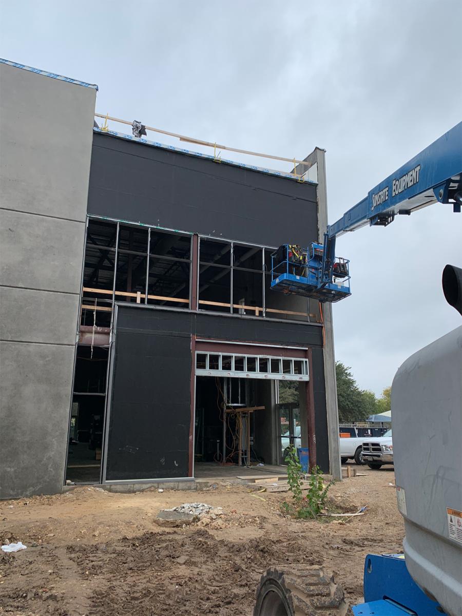 Installation of exterior windows taking place near the gymnasium.