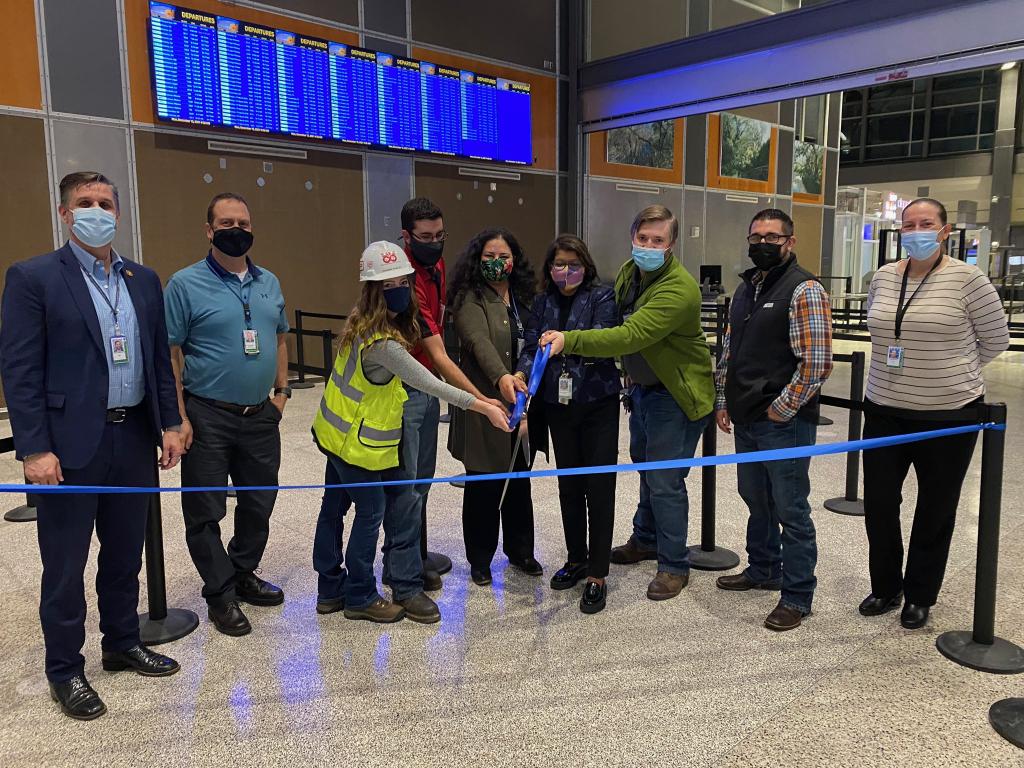 AUS staff cut celebratory ribbon at the opening ceremony for the new TSA Checkpoint in 2021.