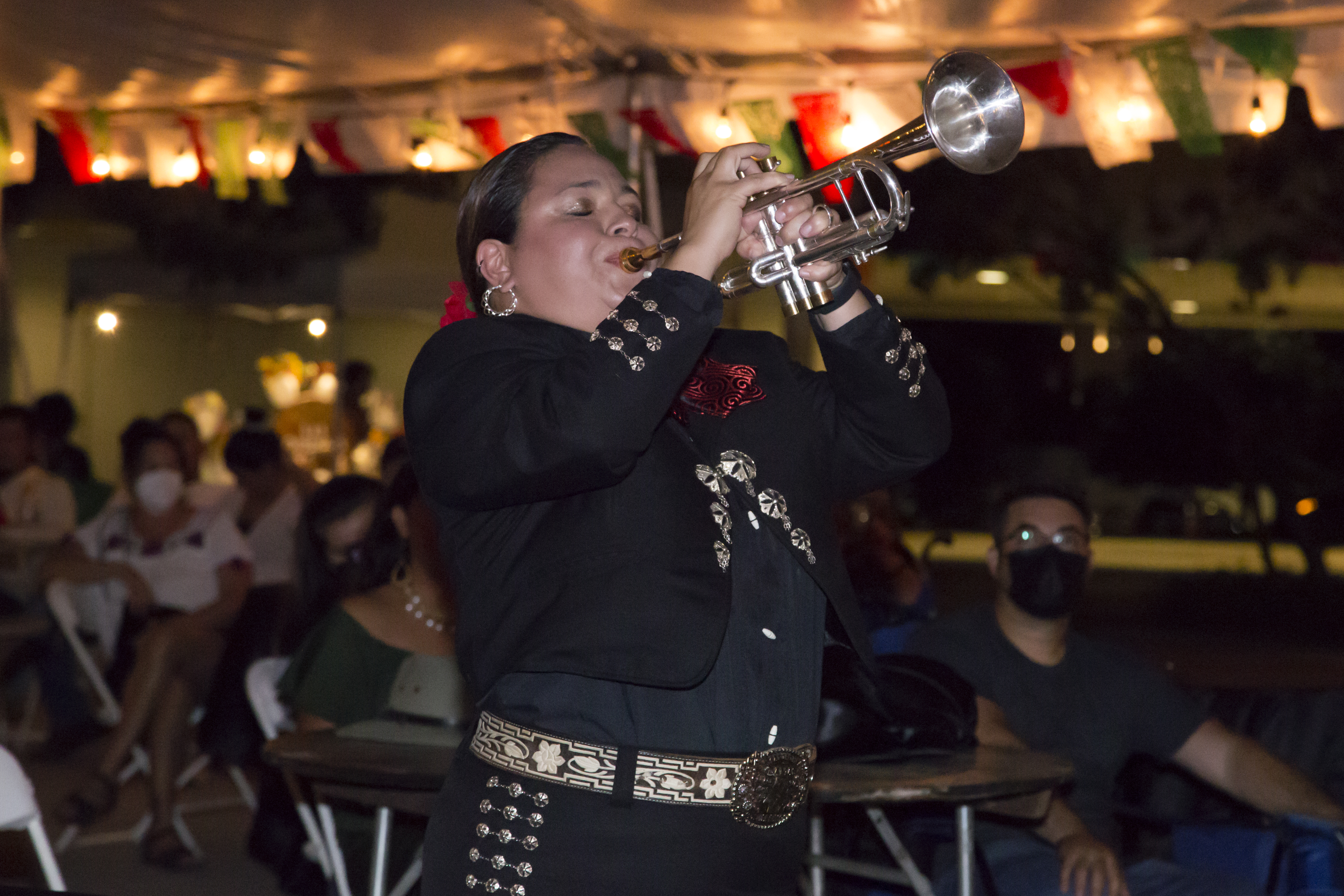Image of a member of Mariachi Las Coronelas playing a trumpet 