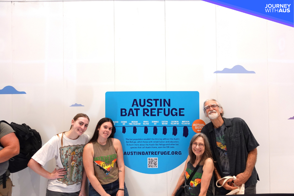 Austin Bat Refuge staff and volunteers in front of bat wall at Austin-Bergstrom International Airport