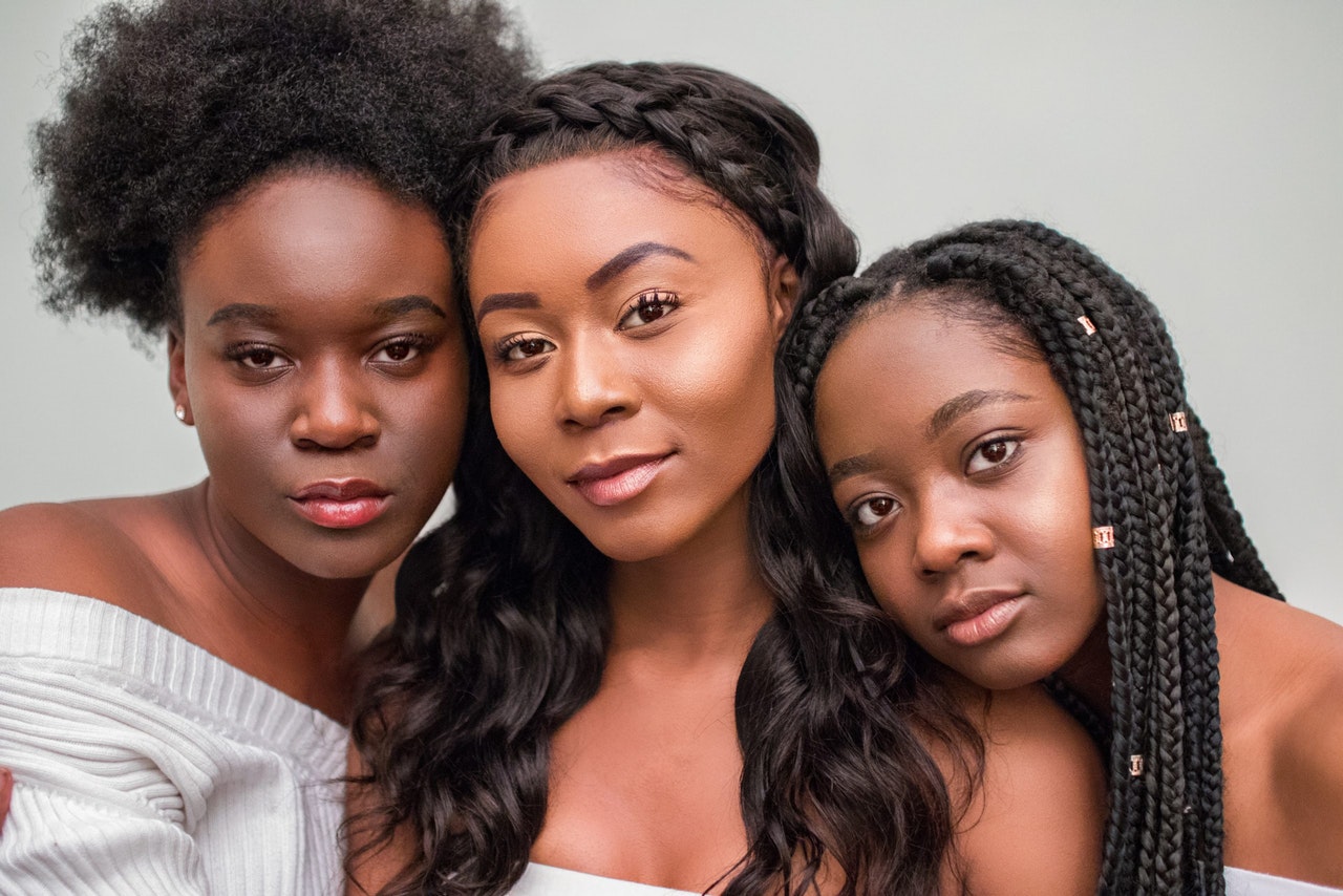 Three women with different natural hair styles