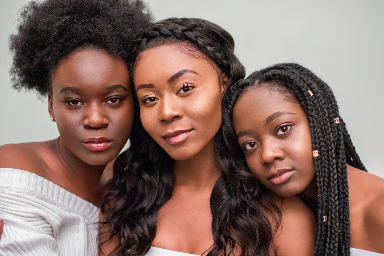 Three women with different natural hair styles 