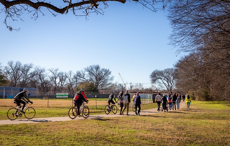 People walking and biking in Govalle Neighborhood Park People walk and bike down an urban trail