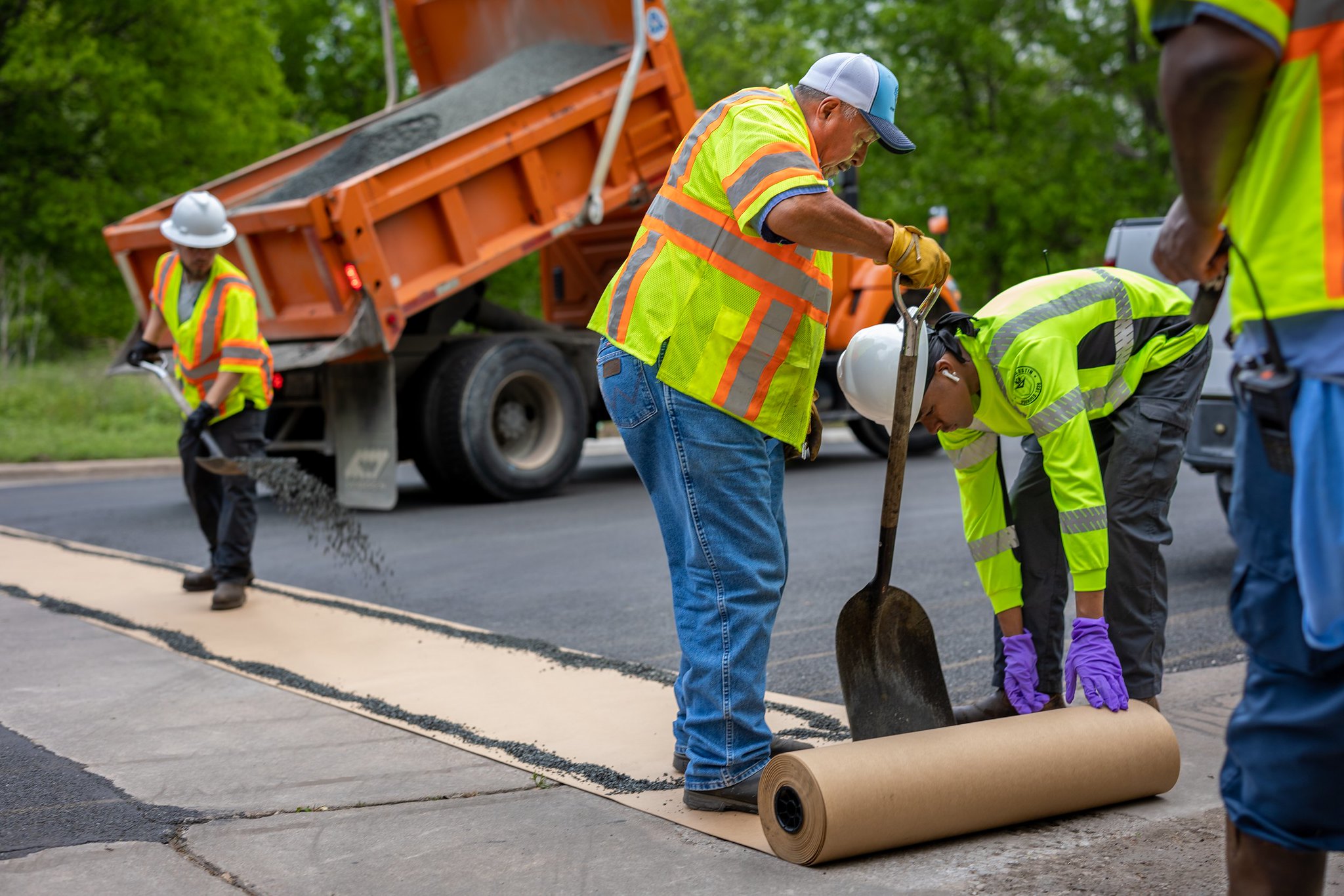 A photo of Austin Public Works crew working on road repair. 