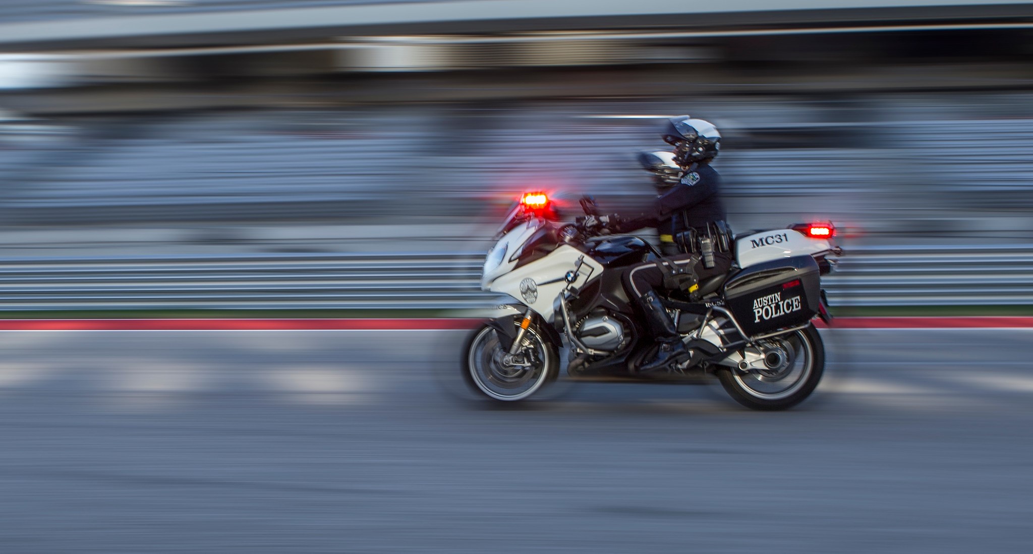 Image of a motorcycle cop driving down the road