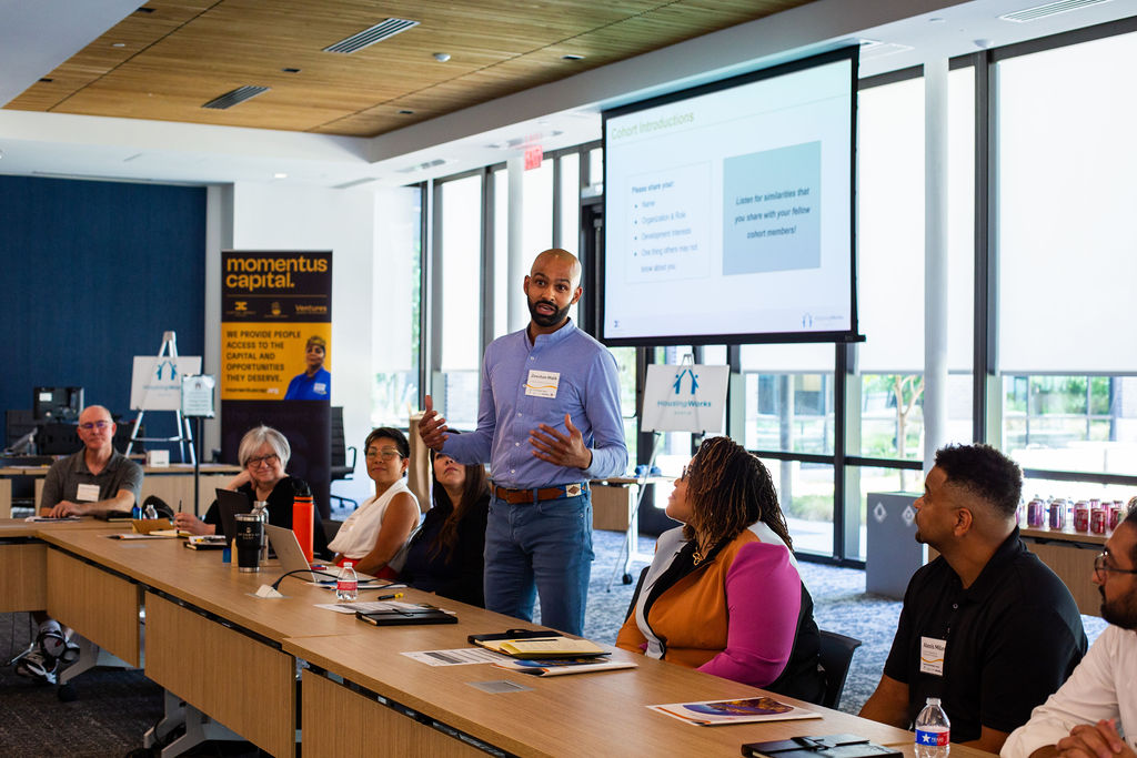 man standing and presenting to the 20 Austin Small Developer Training Program participants