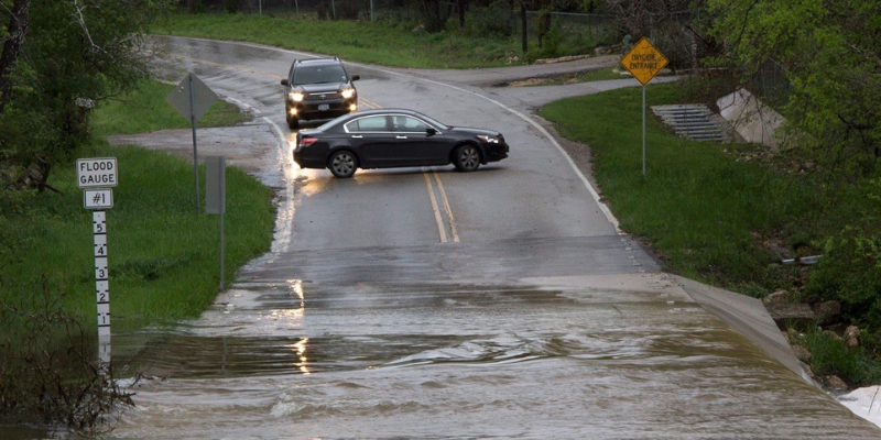 Cars stopped at flooded road