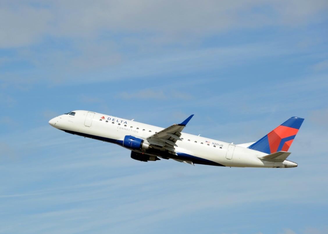 An image of a Delta Air Lines airplane in the sky flying.