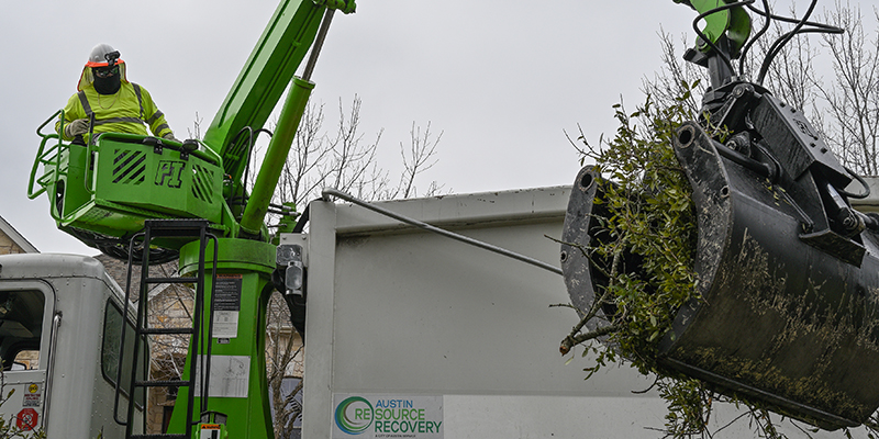 storm debris removal Austin Resource Recovery crane lifting storm debris