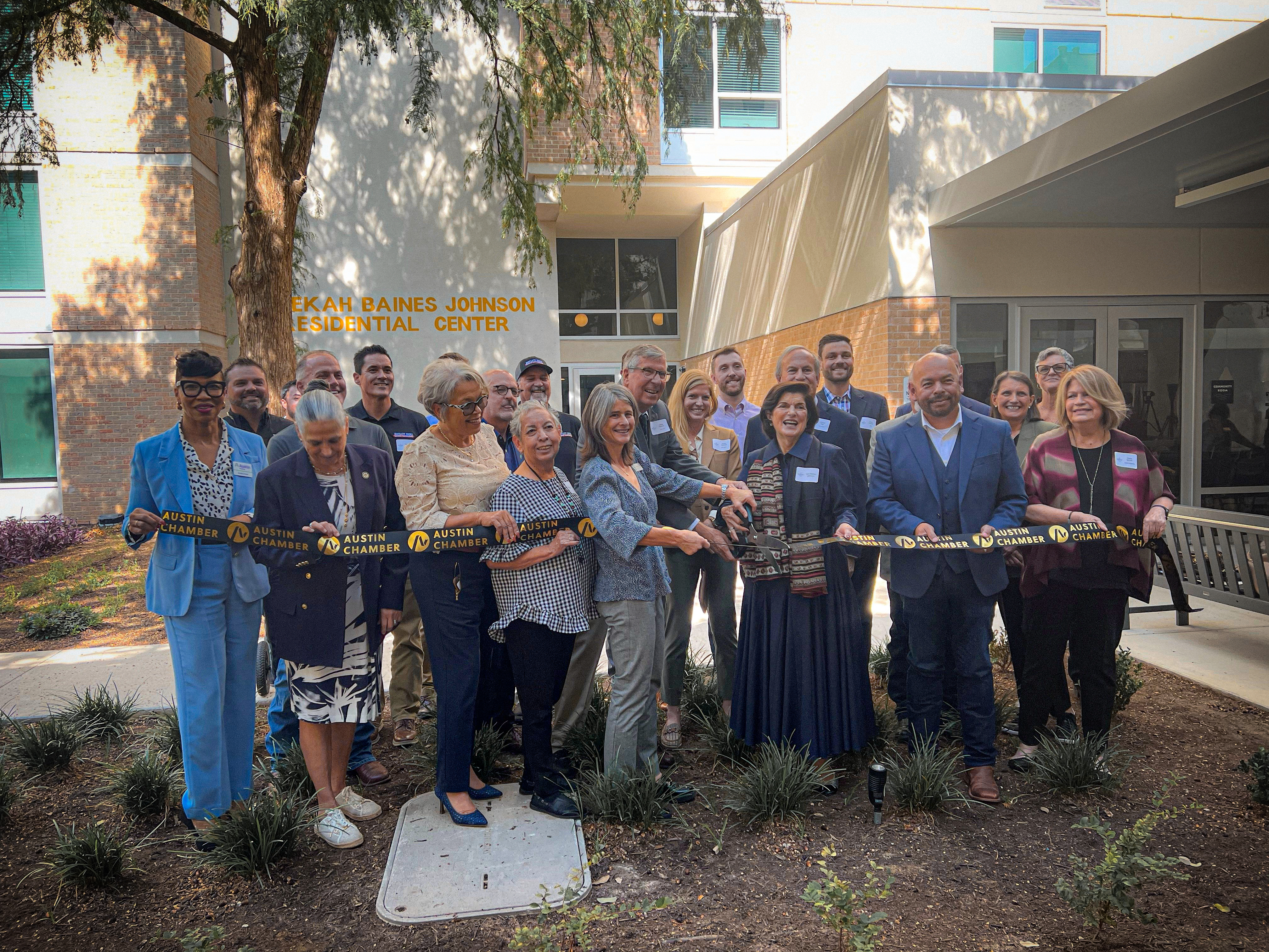 The Rebekah ribbon cutting City and community leaders participate in a ribbon-cutting ceremony at the Rebekah Baines Johnson Residential Center grand reopening.