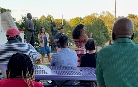 Outdoor event with tables and a speaker