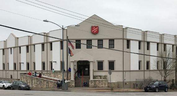 Large white building with the entrance on the corner of the street