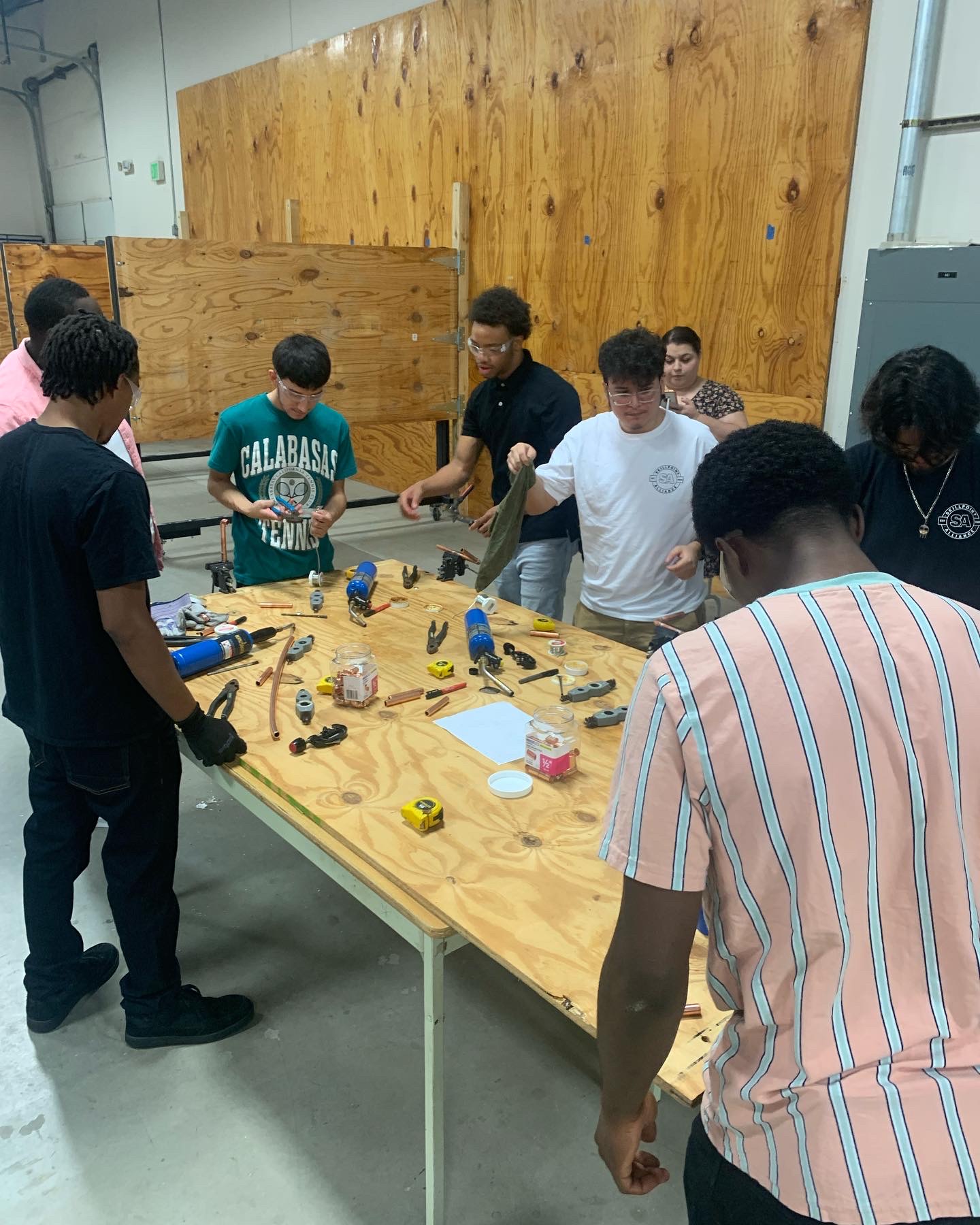 Workforce Development Training Group of students getting experience with common plumbing and electrical tools with Skillpoint Alliance training