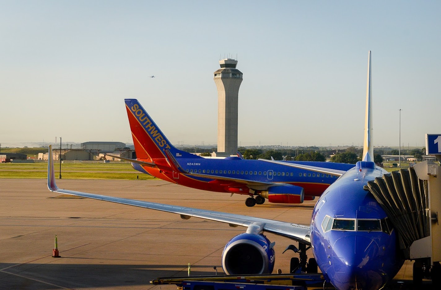 Southwest planes sit on the airfield. The FAA tower is in the background. 