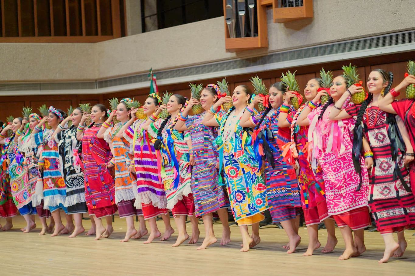 Ballet Folklorico de Austin Members of the Ballet Folklorico de Austin standing in a line with pineapples on their shoulders