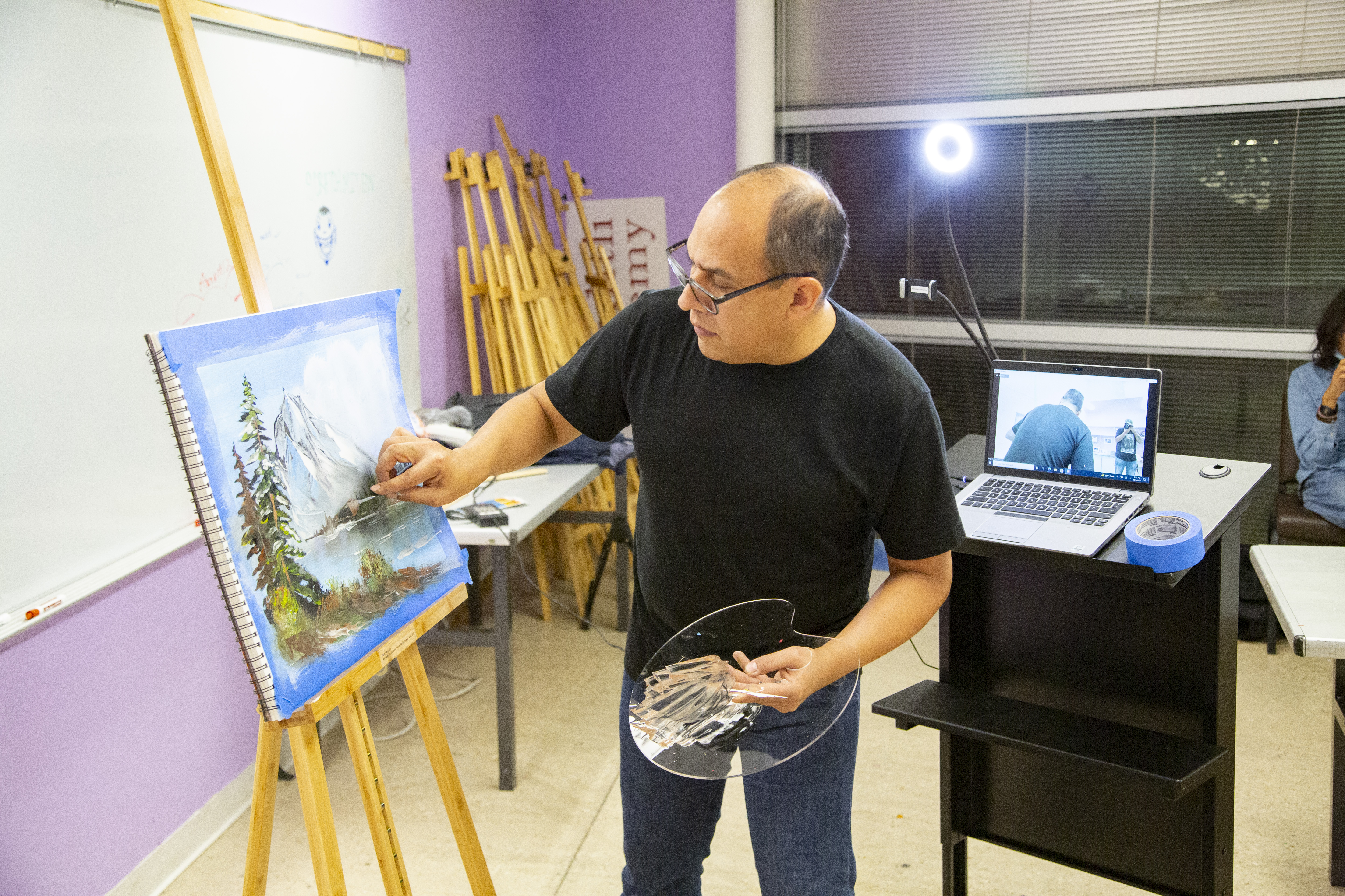 Instructor Miguel Angel Santana during a painting lesson in the Raul Salinas Room at the MACC