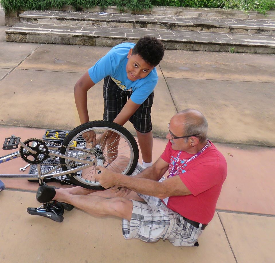 Man and child repair a bicycle Man and child repair a bicycle