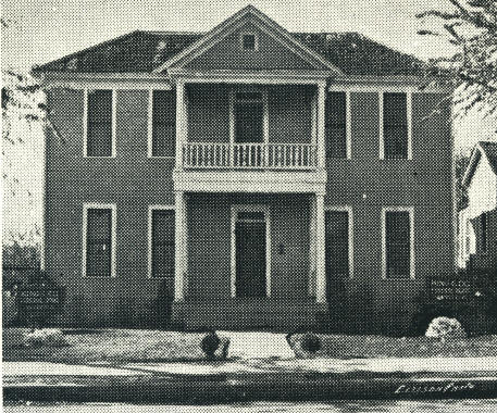 Black and White picture of two story house and front yard to sidewalk