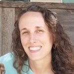 Woman smiling facing the camera. 