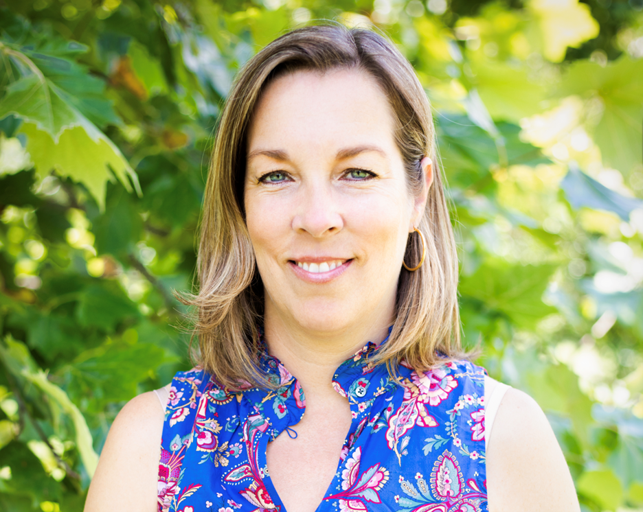 Woman smiling facing the camera. 