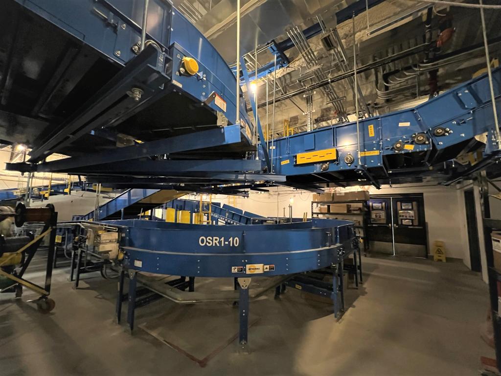 Up close view of baggage handling metal conveyor system. 