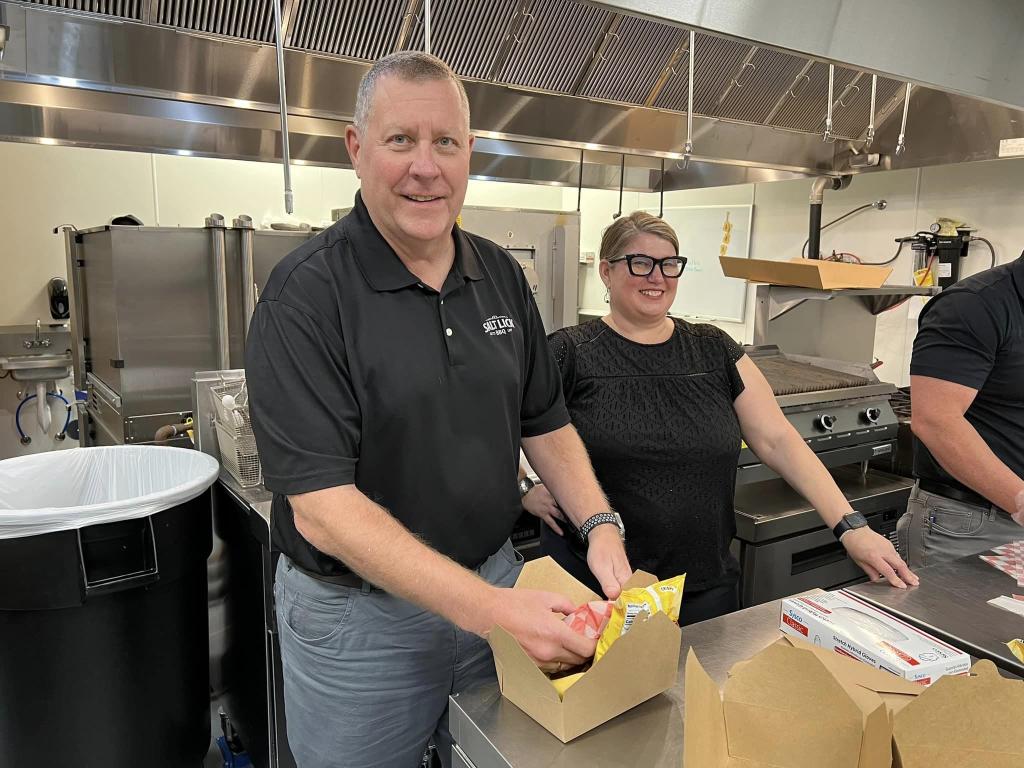 Terry Mahlum of Delaware North preparing to enjoy a barbecue sandwich.