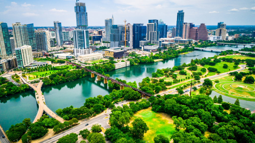 Photo of downtown Austin including Lady Bird Lake and parts of Zilker Park.