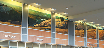 Long, horizonal mural painting, featuring a view of Enchanted Rock and the hill country.