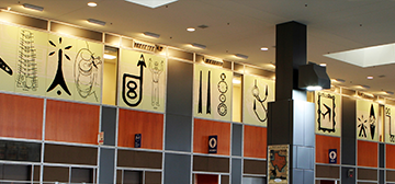 Mural featuring airport iconography above the concourse
