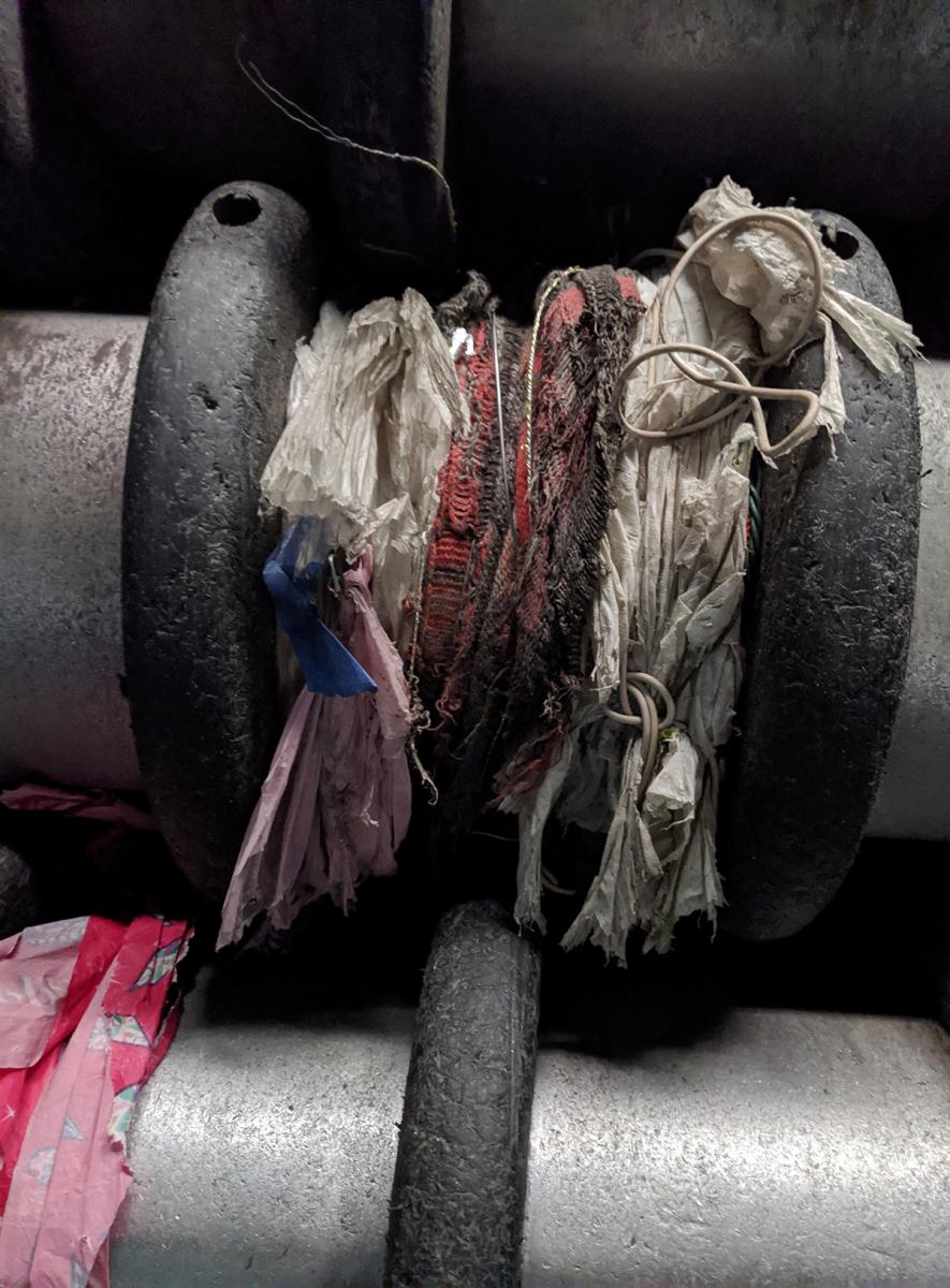 rope and other tanglers wrapped around gears at recycling sorting facility