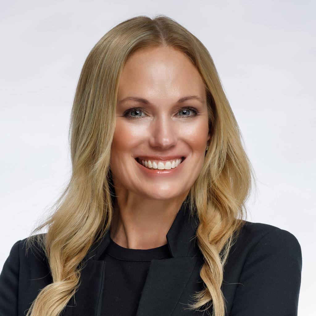 Headshot of woman in suit smiling