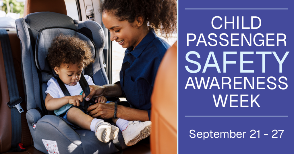Adult secures harness on child in car seat