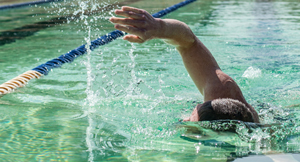 A swimmer makes a lap in Deep Eddy pool.