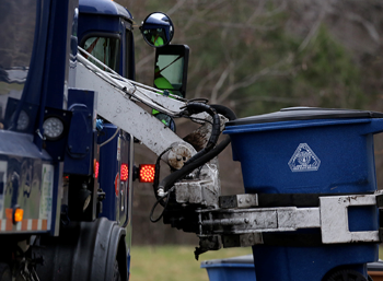 A City of Austin recycling truck picking up a recycling bin