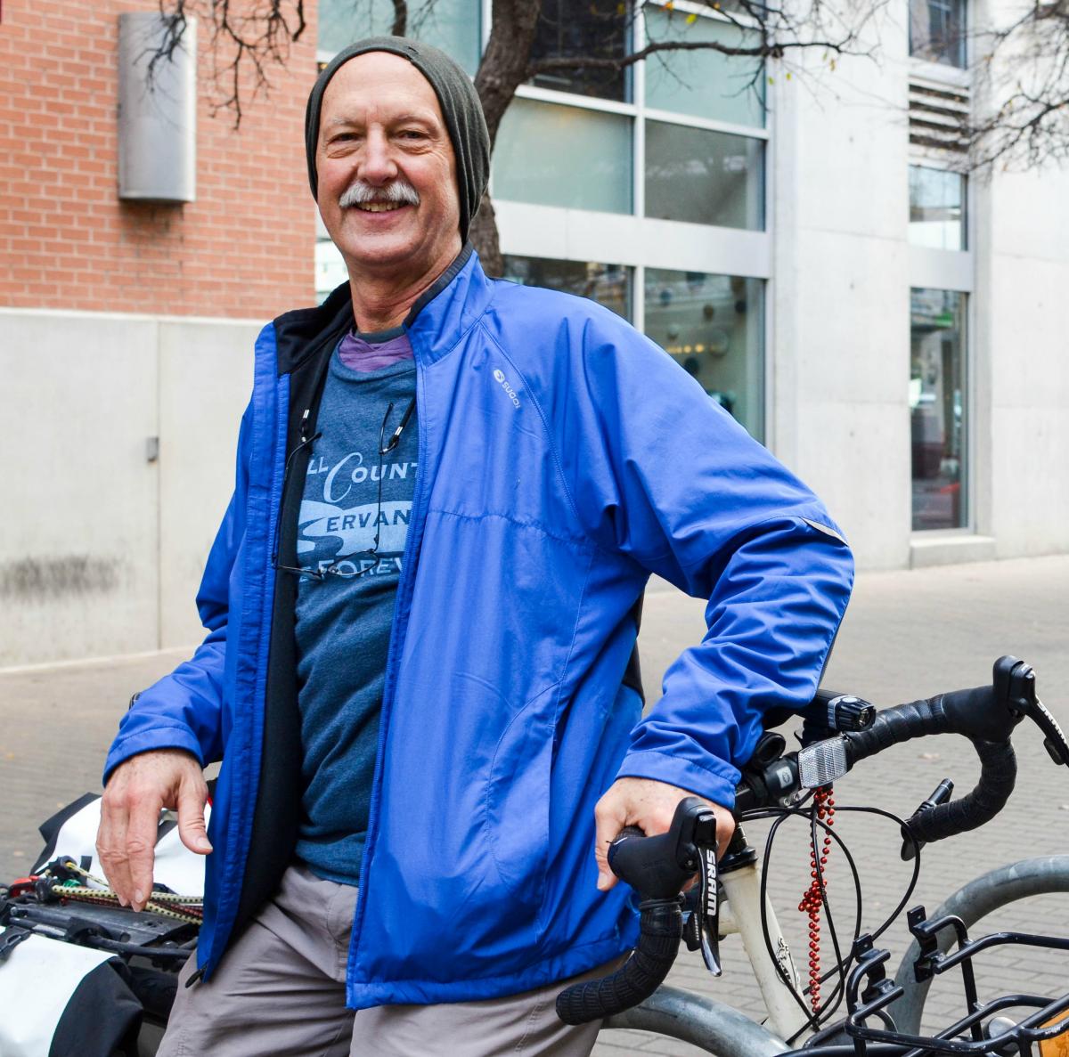 photo of george cofer standing by a bike