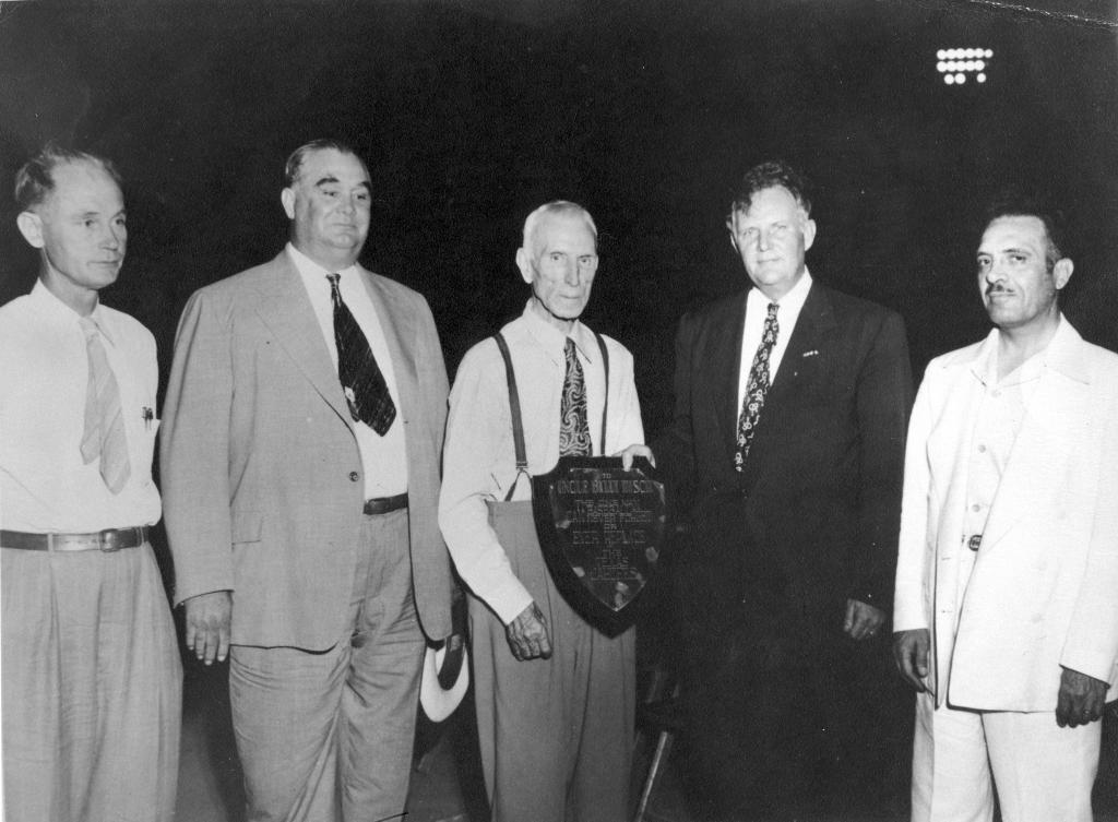 William Disch in middle of group holding plaque