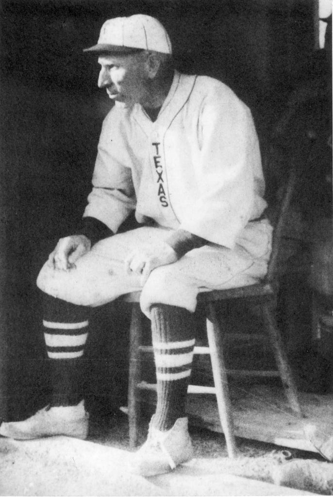 Billy Disch sitting on stool in baseball uniform